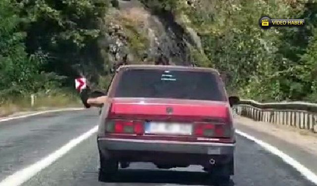KARABÜK’TE TEHLİKELİ YOLCULUK: AYAKLARINI CAMDAN ÇIKARDI